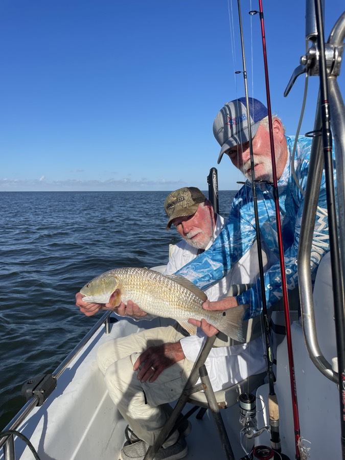 Fishing charter guest displaying a catch.