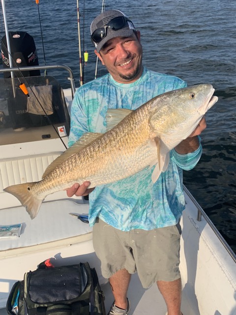 Angler holding a fish during a Reel Rusty charter.